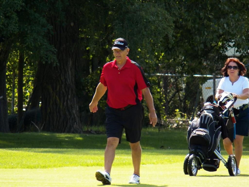  Steve Graczyk walks down the 12th fairway with caddie of the year his wife Alice.